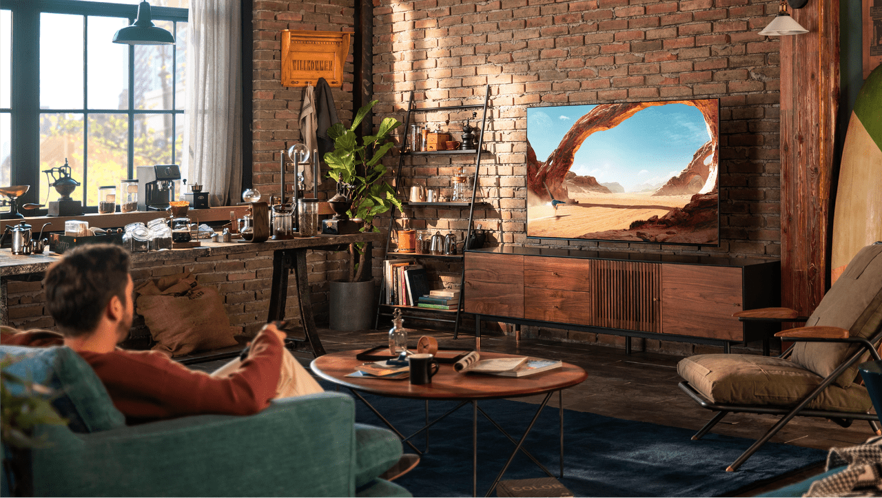 person sitting on couch and watching tv