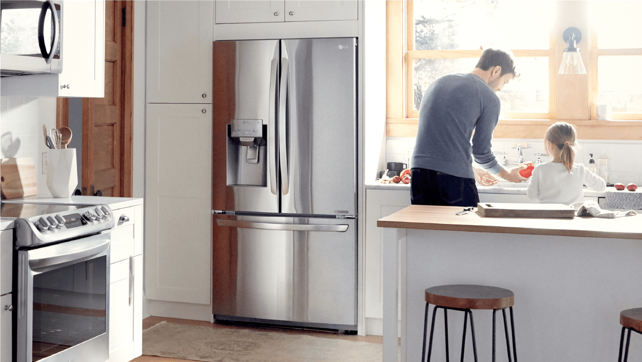 parent and child in kitchen doing dishes