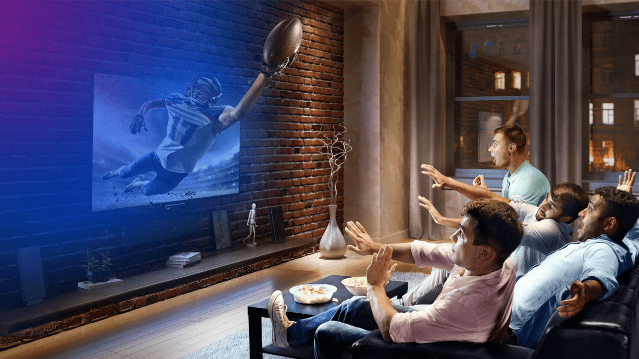 group of people watching TV in living room. Football player is coming out of the screen in a heroic 3D edit