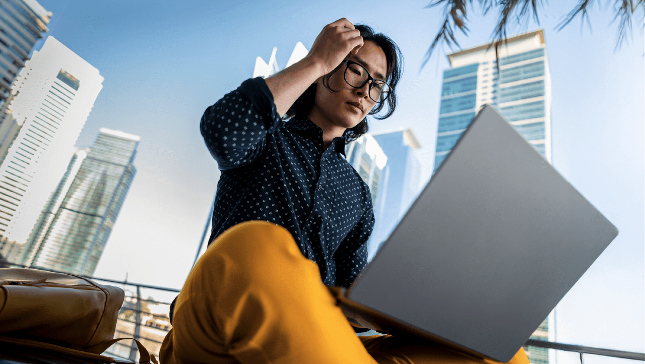 young person using a laptop in the city