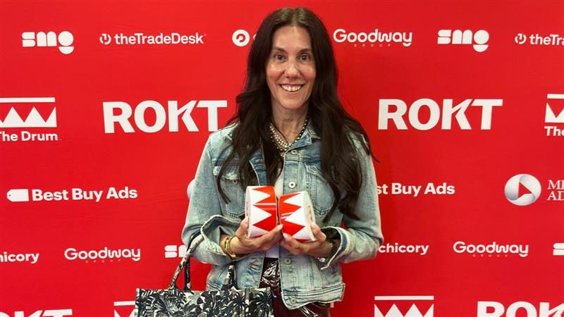 Lisa Valentino holding The Drum Awards. 