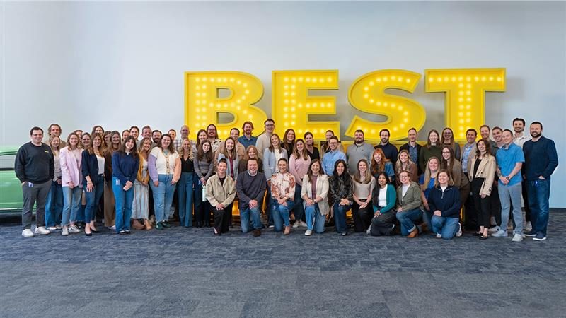 Best Buy Ads PCM Team in front of a Best Buy sign. 