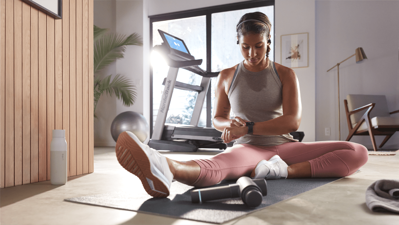 a person checking heart rate monitor after workout